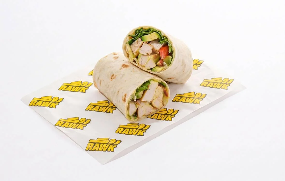 Rawk chicken wrap with avocado and greens on branded paper